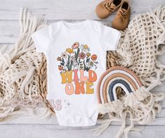 "Take the best pictures ever in cute matching birthday party shirts. Boho wildflower WILD ONE themed birthday outfits. ♥ Our shirts are printed using a high end DTG (Direct to Garment) printer that uses water-based inks which are absorbed into the fabric, creating a smooth finish on the shirt that lasts (no cheap vinyl that cracks or peels!). The ink used is CPSIA (Consumer Product Safety Improvement Act) compliant. ♥ MADE TO ORDER - Please allow 2-6 business days for this item to be made and prepared for shipping. ♥ Go back to my shop: cuteling.etsy.com ♥ Ready to buy? Click the big green \"Add to cart\" button. ♥ Question? Click the small blue \"Contact\" link under my name on the right. ♥ Like it and want to save for later? Click on the heart on the right with \"Add item to favorites\". Thanksgiving Tee Shirts, Dog And Baby, Easter Onesie, Rhinebeck Ny, Bodysuit Shirt, Mommy Shirts, White Onesie, Easter T Shirts, Family Dog