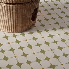 a basket sitting on top of a tiled floor