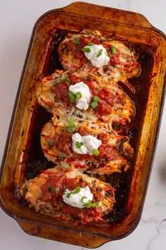 chicken parmesan in a casserole dish with sour cream and green onions