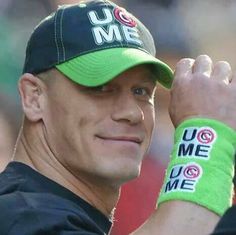 a man wearing a green hat and wrist band