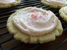 cookies with frosting and sprinkles on a cooling rack