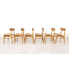 six chairs with wooden seats in a row