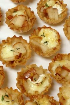 small appetizers are arranged on a white surface