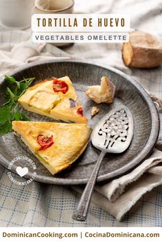 two slices of omelette on a plate with a spoon and cup in the background