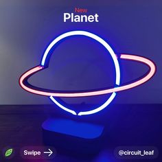 a neon sign that says new planet on it's side and an arrow pointing to the center