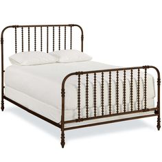 a metal bed frame with white sheets and pillows on it's headboard, against a white background