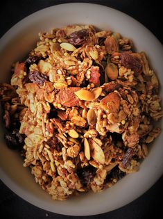 a white bowl filled with granola and nuts