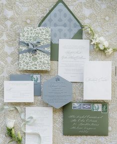 the wedding stationery is laid out on top of each other