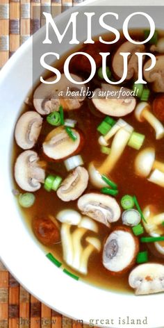 a bowl of miso soup with mushrooms and green onions