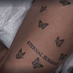 a woman's arm with butterflies on it and the words eternal sunshine written in black ink