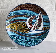 a decorative plate with a sailboat on it