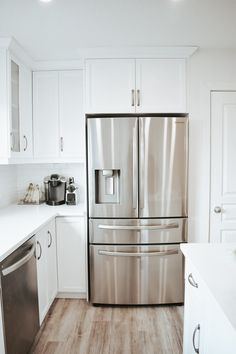 a stainless steel refrigerator in a white kitchen