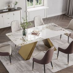 a marble dining table with four chairs around it and a rug on the floor next to it