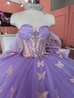 a dress made out of purple tulle with butterflies on it