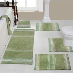 bathroom rugs and bath mats are arranged on the floor