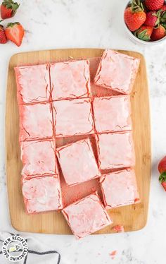 strawberry shortbreads cut into squares on a cutting board