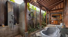 a bathroom with a large tub next to a walk in shower and a wooden ceiling