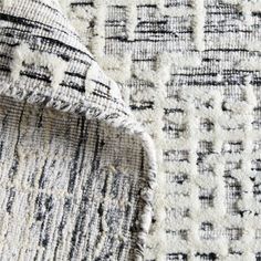 closeup of the texture of a rug with black and white designs on it's edges