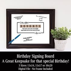 a birthday sign is displayed in front of a potted plant and a framed poster