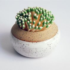 a ceramic bowl with toothbrushes in it