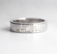 a white gold wedding band with baguettes and diamonds