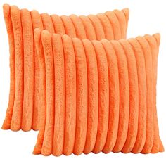 two orange pillows sitting on top of each other