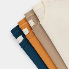 four different colors of t - shirts on a white background