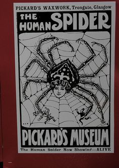 a poster on the side of a building advertising a show called the human spider, pickard's museum