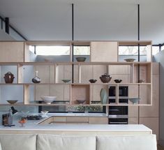 a kitchen with wooden cabinets and white counter tops