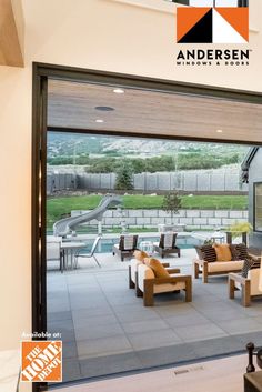 an open living room with sliding glass doors leading to the outside pool and playground area