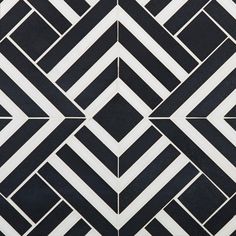 a black and white tiled wall with an interesting design