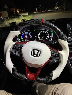 the interior of a car with steering wheel and gauges