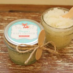 a jar of sea salt next to a wooden spoon on top of a wood table