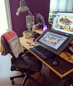 a laptop computer sitting on top of a wooden desk next to a monitor and keyboard