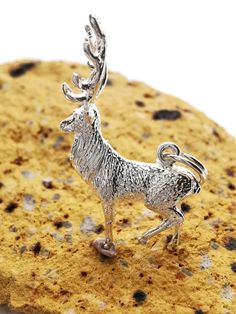 This Vintage style Sterling Silver Stag Charm Pendant measures approximately 16.5mm x 24mm and weighs 2.7g approximately. The charm comes fitted with a Sterling Silver 5mm split ring which opens like a classic keyring to be used to attach to a bracelet or pendant, the wire thickness is approximately 0.56mm.    We also offer 5mm or 6mm jump ring fittings instead of the split ring, please let us know your preference in the 'add a note to LockleyAndAshmore' part at the checkout. These jump rings have a wire diameter of approximately 0.70mm and are left unsoldered so they can be added to a bracelet or necklace.  This Charm Pendant has been hand finished to a very high standard.  It does not carry a  British hallmark. UK Law states that silver items under the weight of 7.8grams do not have to b Vintage Sterling Silver Charm Necklace With Lobster Clasp, Adjustable Sterling Silver Horse Design Jewelry, Antique Silver Charms With Lobster Clasp, Christmas Stocking Gifts, Nickel-free Silver Novelty Charms, Collectible Silver Vintage Charm, Silver Items, Personalized Cufflinks, Stocking Gifts