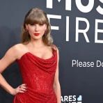 taylor swift at an event wearing a red dress