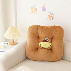 a brown pillow sitting on top of a white couch