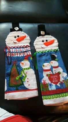 two oven mitts decorated with snowmen on them