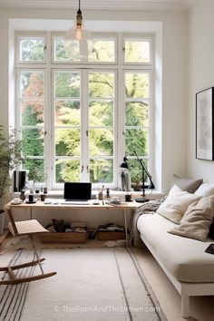 a living room filled with furniture and windows