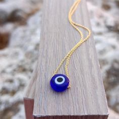 14k gold filled, Greek mati blue evil eye necklace. High quality chain. Elegant&dainty catching gently everyone's attention. Ideal for birthday or anniversary gift. Beautiful evil eye charm, that protects the person that is wearing it. Handmade in Greece! An eye catching blue evil eye charm! The perfect gift for every woman. Length approx. 14 inches Also available in 15 to 18 inches ♡All items will be delivered nicely gift wrapped! * Read our policies before purchase: https://www.etsy.com/shop/J Blue Cable Chain Jewelry As A Gift, Blue Cable Chain Necklace For Gifts, Blue Sterling Silver Necklace With Delicate Chain, Blue Round Cable Chain Necklace, Blue Pendant Necklace With Cable Chain, Minimalist Blue Evil Eye Jewelry, Blue Minimalist Evil Eye Jewelry, Blue Sterling Silver Cable Chain Jewelry, Silver Necklace With Evil Eye Round Pendant