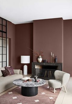 a living room with brown walls and furniture