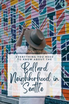 a woman wearing a hat standing in front of a colorful wall with the words, everything you need to know about the ballard neighborhood in seattle