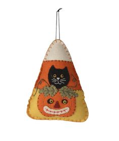 an ornament shaped like a pumpkin with a black cat on it's head