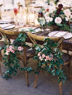 the table is set with flowers and greenery for an elegant wedding reception or special event