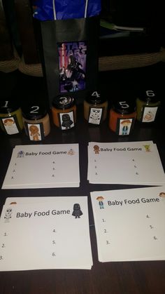 four baby food game cards sitting on top of a table