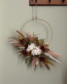 a flower arrangement hanging on the wall