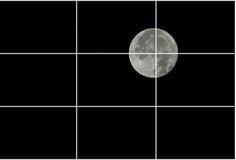 the full moon is seen through grids in black and white