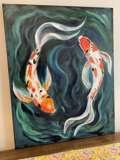 two orange and white koi fish swimming in the water