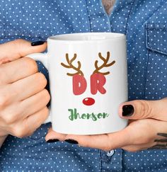 a woman holding a coffee mug with reindeer antlers on it and the words dr