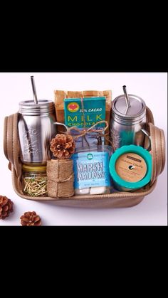 the coffee lover's gift basket is packed with two mugs and other items